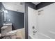 Bathroom featuring a shower-tub combo, wood-look flooring, and modern fixtures at 4957 Day Lily Nw Way, Acworth, GA 30102