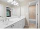 Bathroom featuring double sink vanity, large mirror, and tiled shower and tub combo at 4957 Day Lily Nw Way, Acworth, GA 30102