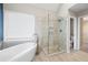 Modern bathroom featuring soaking tub, walk-in shower, and neutral tiling at 4957 Day Lily Nw Way, Acworth, GA 30102