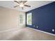 Comfortable bedroom with neutral carpet, light walls and a striking navy accent wall at 4957 Day Lily Nw Way, Acworth, GA 30102