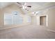 Large main bedroom with tray ceilings, multiple ceiling fans, and generous natural light at 4957 Day Lily Nw Way, Acworth, GA 30102