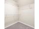 Walk-in closet with wall-mounted shelving units and plush carpeting at 4957 Day Lily Nw Way, Acworth, GA 30102