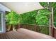 Wooden deck surrounded by lush trees at 4957 Day Lily Nw Way, Acworth, GA 30102