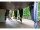 Covered deck with ambient string lighting and privacy curtains at 4957 Day Lily Nw Way, Acworth, GA 30102