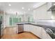 Bright kitchen features white cabinets, stainless steel appliances, and breakfast nook at 4957 Day Lily Nw Way, Acworth, GA 30102