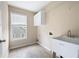 Functional laundry room featuring tile flooring, utility sink, and convenient storage at 4957 Day Lily Nw Way, Acworth, GA 30102