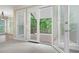 Living room with double doors leading out to a wooden deck and backyard at 4957 Day Lily Nw Way, Acworth, GA 30102