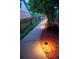 Illuminated walkway lined with mulch and lush greenery at 4957 Day Lily Nw Way, Acworth, GA 30102