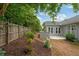Picturesque backyard featuring partial privacy fence, patio, outdoor kitchen, and landscaping for a serene outdoor living space at 613 Wiley Ct, Canton, GA 30115