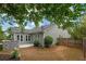 Backyard featuring a patio, lush greenery, privacy fence, outdoor kitchen, and partial shade from mature trees at 613 Wiley Ct, Canton, GA 30115