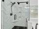 This bathroom features a glass shower with black fixtures and a herringbone tile design at 613 Wiley Ct, Canton, GA 30115