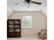 Lofted bedroom with ceiling fan, and a built-in bookshelf near a large window at 613 Wiley Ct, Canton, GA 30115