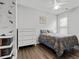 This bedroom features luxury vinyl floors, a ceiling fan, and a four-drawer dresser at 613 Wiley Ct, Canton, GA 30115