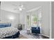 A bright bedroom with a ceiling fan, bay window and a cozy chair at 613 Wiley Ct, Canton, GA 30115