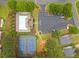 Overhead view of community pool, tennis courts, playground, with nearby parking and landscape at 613 Wiley Ct, Canton, GA 30115