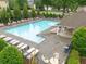 A serene community pool with lounge chairs and shade covers a relaxing and inviting recreation space at 613 Wiley Ct, Canton, GA 30115