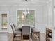 Sunlit dining area showcases modern lighting, stylish chairs, and a view of the outdoors at 613 Wiley Ct, Canton, GA 30115