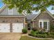 Charming home featuring a stone facade, well-manicured landscaping, and a two-car garage at 613 Wiley Ct, Canton, GA 30115