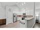 Bright kitchen features stainless steel appliances, white cabinets, and hardwood flooring at 613 Wiley Ct, Canton, GA 30115