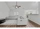 Bright, open living room features a ceiling fan, a large sectional sofa and durable flooring at 613 Wiley Ct, Canton, GA 30115