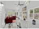 Bright sunroom with vaulted ceilings, a ceiling fan, large windows, and a cozy dining area with modern decor at 613 Wiley Ct, Canton, GA 30115