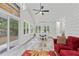 Spacious sunroom with tiled floors, dining table, and cozy seating area flooded with natural light through large windows at 613 Wiley Ct, Canton, GA 30115