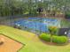 Tennis courts with lights surrounded by fences and green areas are visible at 613 Wiley Ct, Canton, GA 30115
