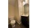 This half bathroom features a dark vanity with an oval mirror and modern lighting at 143 Ilex Dr, Canton, GA 30114