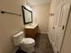 Bathroom featuring vanity, toilet, tile floor and a mirror with a black frame at 143 Ilex Dr, Canton, GA 30114