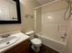 Bathroom has a single sink vanity, large mirror, toilet and bath-shower combo at 143 Ilex Dr, Canton, GA 30114