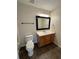 Bathroom features ceramic tile flooring, mirror, vanity, and toilet at 143 Ilex Dr, Canton, GA 30114