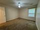 Bedroom with carpet, ceiling fan, window with blinds, and door at 143 Ilex Dr, Canton, GA 30114
