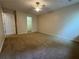 Bedroom with carpeted floors, a ceiling fan, and a closet for ample storage at 143 Ilex Dr, Canton, GA 30114