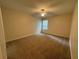 Neutral bedroom featuring plush carpeting, a ceiling fan, and a window for natural light at 143 Ilex Dr, Canton, GA 30114