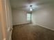 Small bedroom with tan carpet, one window, and a ceiling fan at 143 Ilex Dr, Canton, GA 30114