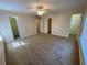 A large bedroom with carpet and ceiling fan, featuring two walk-in closets with white doors at 143 Ilex Dr, Canton, GA 30114