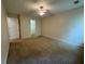 Bedroom with neutral colored carpet, ceiling fan, and door leading to closet at 143 Ilex Dr, Canton, GA 30114