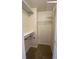 Walk-in closet with shelving, rod, carpet and textured ceiling at 143 Ilex Dr, Canton, GA 30114