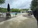 Community pool with lounge chairs, tables, and umbrellas at 143 Ilex Dr, Canton, GA 30114