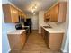Modern kitchen featuring stainless steel appliances, wood cabinets, and hardwood floors at 143 Ilex Dr, Canton, GA 30114