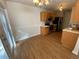 Well-lit kitchen with stainless steel appliances and hardwood floors, adjacent to dining area at 143 Ilex Dr, Canton, GA 30114