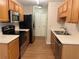 The kitchen features stainless steel appliances, wood cabinets and plenty of counter space at 143 Ilex Dr, Canton, GA 30114