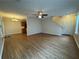 Open-concept living area with modern ceiling fan, hardwood floors, and staircase at 143 Ilex Dr, Canton, GA 30114