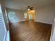 Spacious living room featuring hardwood floors, a ceiling fan, and ample natural light from the windows at 143 Ilex Dr, Canton, GA 30114