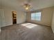 This bedroom features carpeted floors, a ceiling fan, and a bathroom at 143 Ilex Dr, Canton, GA 30114