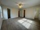 Large main bedroom has carpeted floors, natural light, and two closets at 143 Ilex Dr, Canton, GA 30114