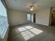 Large bedroom with carpeted floor, neutral walls, and a ceiling fan at 143 Ilex Dr, Canton, GA 30114