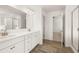 Double sink bathroom vanity with modern fixtures, wood look tile flooring and walk in shower at 1851 Lacebark Elm Way, Lawrenceville, GA 30045