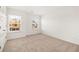A bright bedroom features two windows and neutral carpet at 1851 Lacebark Elm Way, Lawrenceville, GA 30045
