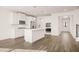 Modern kitchen with stainless steel appliances, large island, and easy access to dining and living areas at 1851 Lacebark Elm Way, Lawrenceville, GA 30045